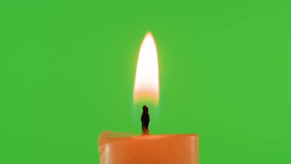Burning Wax Candle on Green Chroma Key Background alt
