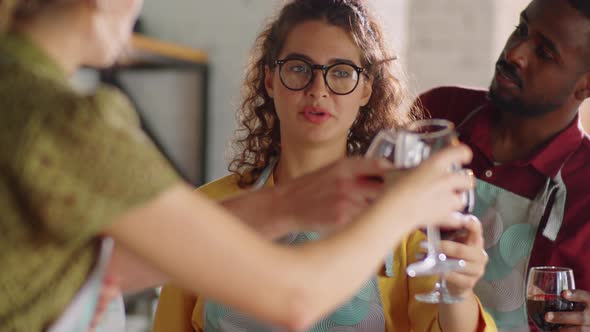 Multiethnic Friends Drinking Wine during Cooking Master Class alt