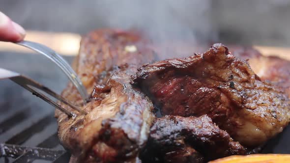 Man Cooking Argentine Meat on a Grill Outdoors.  alt