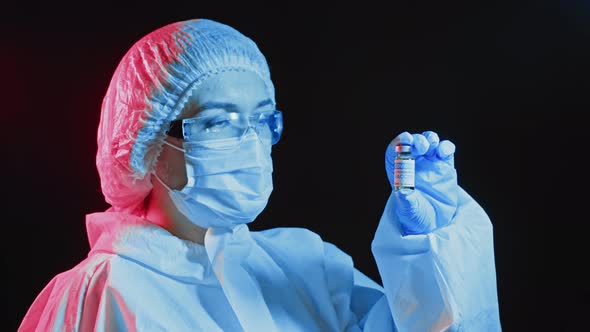 A scientist doctor at a pharmaceutical company developing a drug in a laboratory holds a vaccine. alt