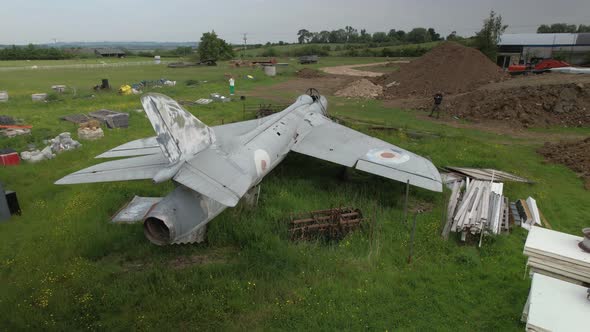 Rear aerial view behind Hawker hunter abandoned wt804 fighter jet among discarded junk in British f alt