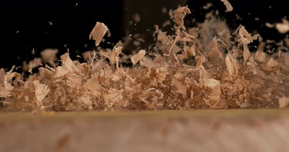 Wood Chips Falling on a Board, Slow Motion 4K alt
