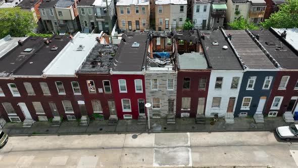 Boarded up homes in inner city America. Poverty in urban community in USA. Aerial tilt up reveal on alt