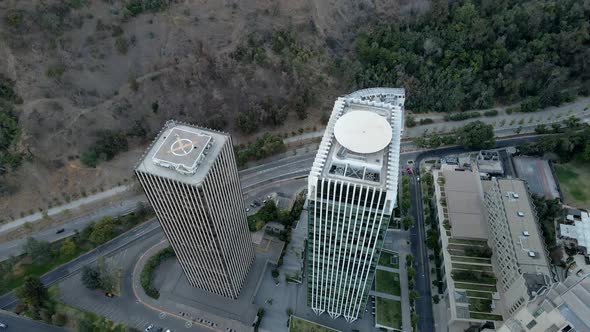 Aerial top down of Santa Maria towers and cars driving in avenues next to Met Park in San Cristobal alt