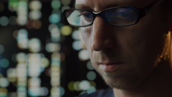 Close-up portrait of a young man working at the computer. alt