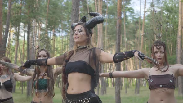 Deft Women Dancers with Make-up and in Mystical Fabulous Costumes Dancing Groovy Dance in Nature alt