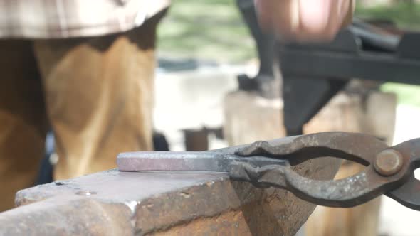 Blacksmith Forges Metal on Anvil alt