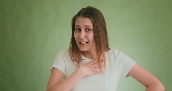 Funny Woman Tries to Understand Friend Posing on Green alt