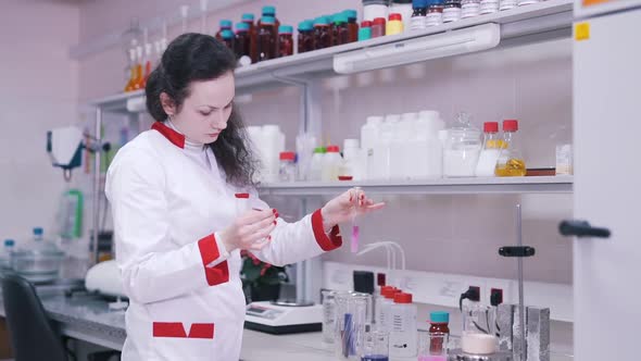 Scientist Works with Liquids in Lab