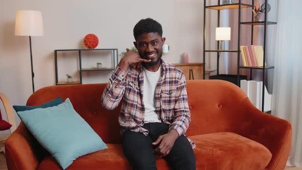 African American Realtor Man Looking at Camera Doing Phone Gesture Like Says Hey you Call Me Back alt