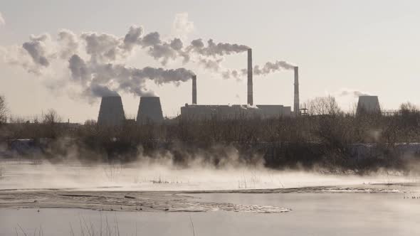 Dark Smoke From Pipes in the Air at Sunset alt