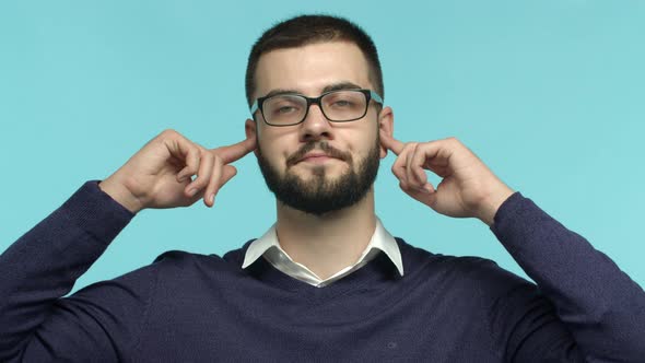 Slow Motion of Ignorant Guy in Glasses Unwilling to Listen Sighing and Shut Ears with Fingers