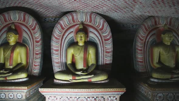 DAMBULLA, SRI LANKA - FEBRUARY 2014: The view of three sitting Buddhas at the Golden Temple of Dambu alt