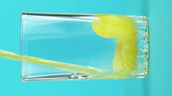 Vertical Video Closeup Shot of Fruit Fizzy Orange Cold Beverage Drink Pooring Into Threaded Glass