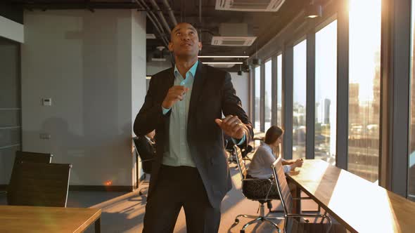 Atractive Aframerican Businessman Celebrating Promotion with Funny Dance Walk alt