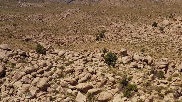 Aerial shot of interesting rock formations in the desert of California alt