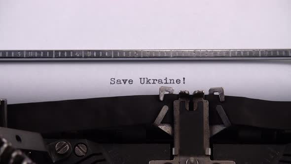 Typing phrase "Save Ukraine !" on retro typewriter. alt