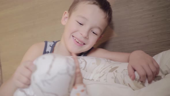 Happy young caucasian boy with his baby sister alt