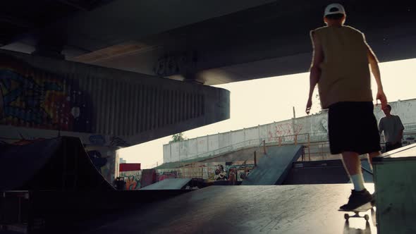 Sporty Teens Practicing Together with at Skatepark alt