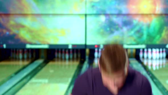 Man Shows His Thumbs Up at the Bowling Alley alt