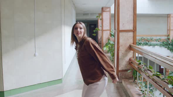 Young Woman Is Looking at Camera and Dancing