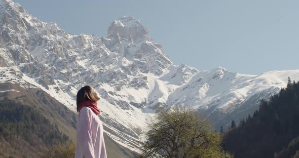 Young Woman Enjoying a Beautiful View with Mountains Outdoors