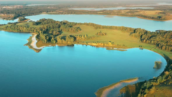 Aerial View Of Lake And Green Forest Landscape In Sunny Summer Morning alt