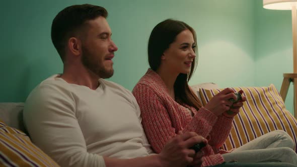 Young Couple Enjoys Playing Computer Games