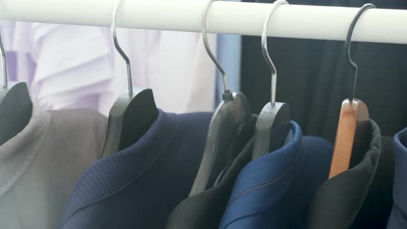 Business Shirt and Suits on a Hanger in a Store alt