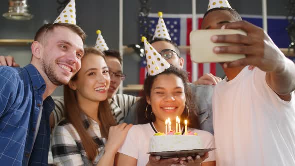 Birthday girl taking selfie photo with friends