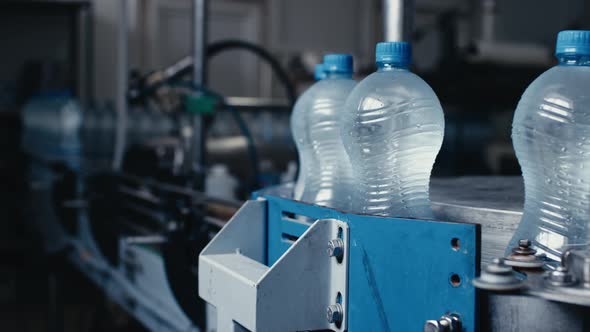Water Bottles Moving on Automatic Conveyor Line in Water Production Factory