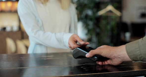 Mobile Payment Concept Close Up of Young Woman Pays Using Credit Card Contactless Payment for Her alt