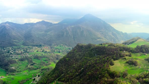 Aerial Video of the Small Town of Pasturo in Lombardy North Italy Showing Mountain Panorama Forest alt