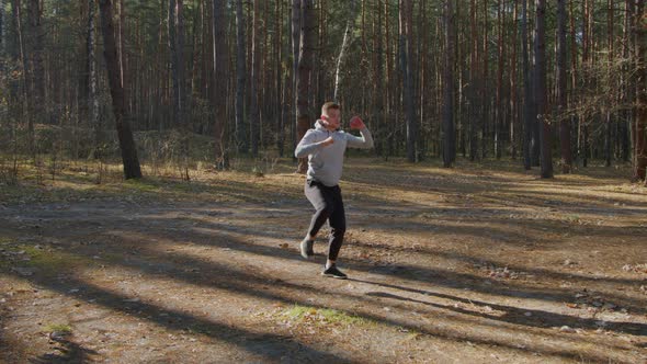 Young Man Is Training In Forest