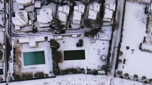 aerial view of snowy houses and swimming pool