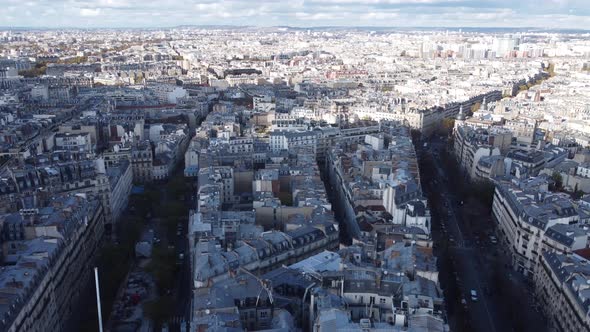 Drone View of the Streets of Paris with the Sunlit City in the Background