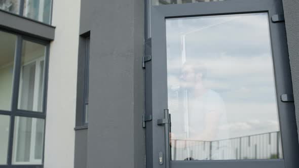 Goods Delivery. Customer Puts His Signature On The Phone And Receives His Box. alt