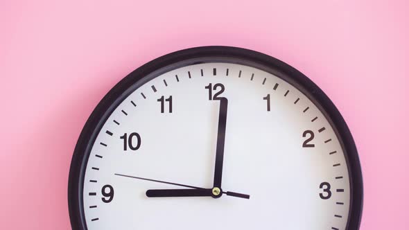 Black Clock on Pink Background Close Up alt