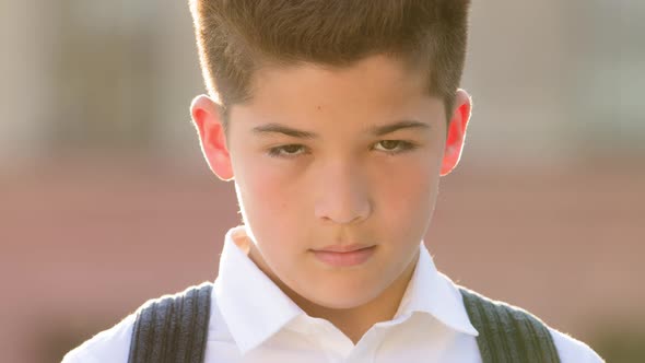 Male Portrait Face Sad Offended Upset Worried Little Boy Son Child Hispanic Pupil with Backpack alt