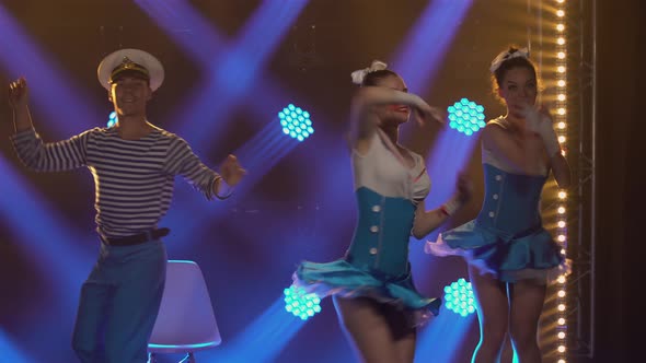 Three Pretty Women in Seductive Sailor Suits Dance Incendiaryly with Their Partner in a Sailor Cap alt