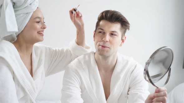 Portrait of Funny Couple Doing Makeup at Home
