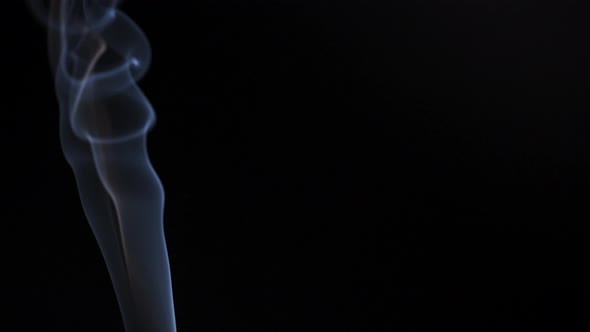 Abstract Smoke Rises Up in Beautiful Swirls on a Black Background alt