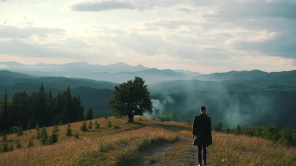 a Guy Walking in Nature Among the Mountains