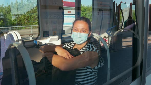 Woman in mask in tram