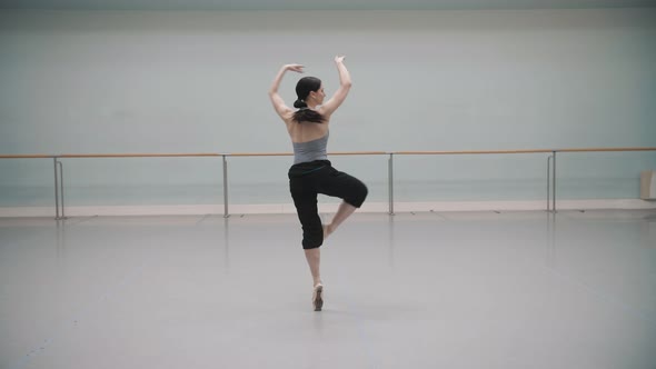 Ballerina rotates during rehearsal. Ballet dancer. Pirouette. Ballet pointe shoes.   Beautiful rotat