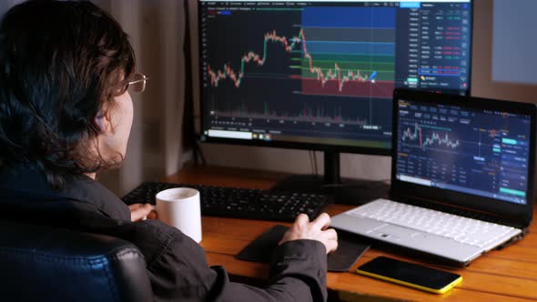 Male Trader Works at Home in an Office