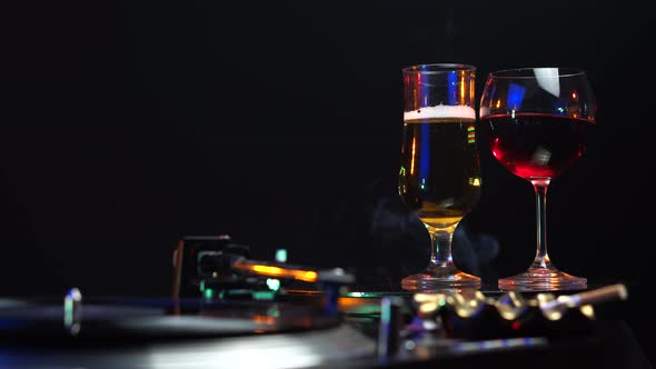 Vinyl on Gramophone Glasses With Beer Red Wine Cigarette Smoke Party Scenery alt