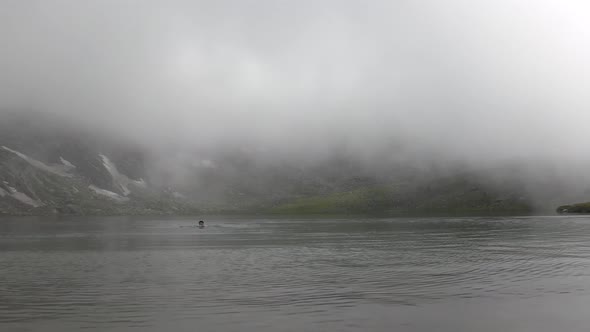 Man Swimming in Cold Lake