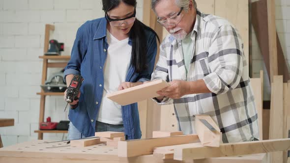 Senior man and woman working with wood alt