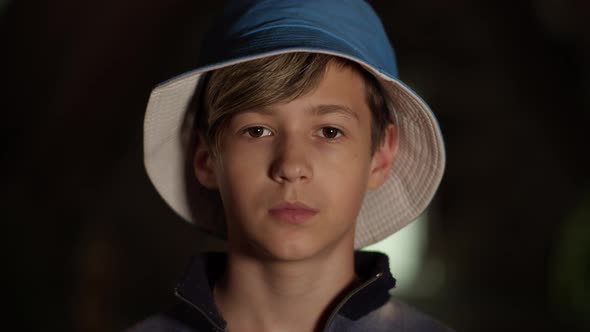 Portrait of a Sad Serious Boy in Hat Looking at the Camera Indoors Camera Bump